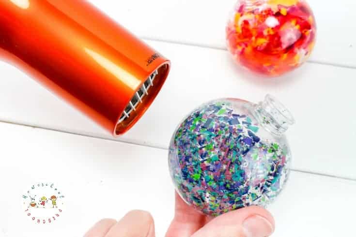 Kids will love the watercolor look of these melted crayon Christmas ornaments. They'll also love how easy they are to make. What a perfect motor skill builder!