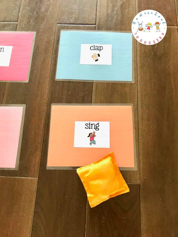 Set up this educational bean bag toss game! It's a great way to help kids learn action words (verbs) and build gross motor skills at the same time. 