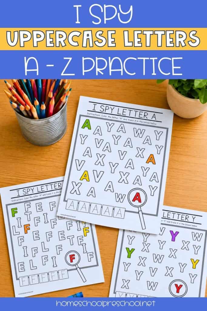 Three I Spy uppercase letter worksheets spread on a wooden table next to a cup of colored pencils, showing completed letter A, F, and Y search and trace pages.