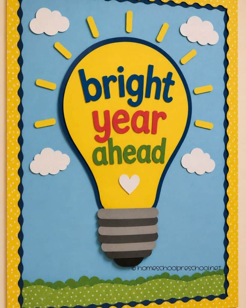 Bright Year Ahead classroom bulletin board featuring a large paper light bulb, clouds, sunshine, and the words "Bright Year Ahead."