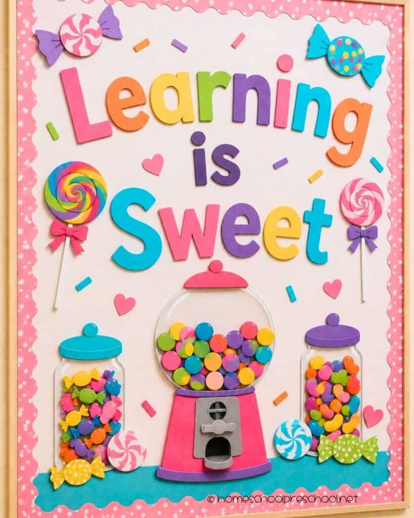Learning Is Sweet preschool bulletin board with colorful paper candy, lollipops, candy jars, a gumball machine, and the words "Learning Is Sweet."