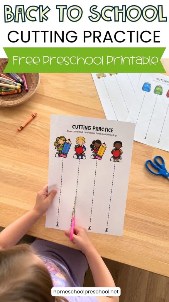 Preschooler using scissors with a Back to School cutting practice worksheet featuring school-themed pictures and straight cutting lines.