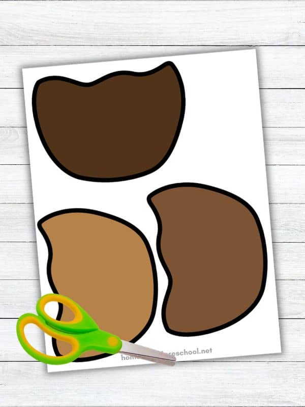 Candy apple craft template featuring three brown chocolate and caramel coating cutouts in different shades, with child-safe scissors for a preschool cut-and-paste activity.